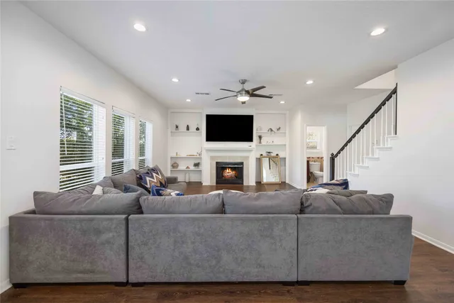 a living room with furniture a fireplace and a flat screen tv