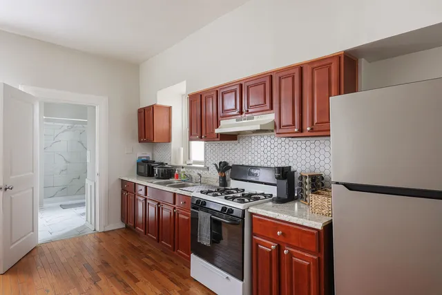 a view of a workspace with furniture and wooden floor