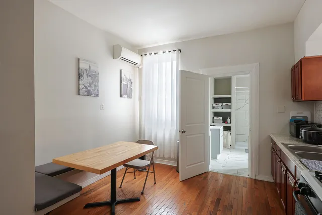 a room with painting on the wall and a wooden floor