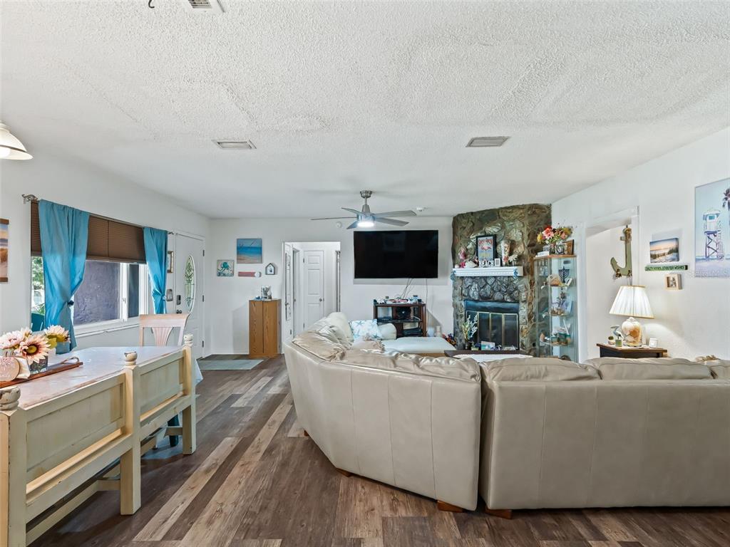 6046 East Loring Lane Inverness, FL 34452 - Photo 12 of 46 a living room with furniture and a flat screen tv