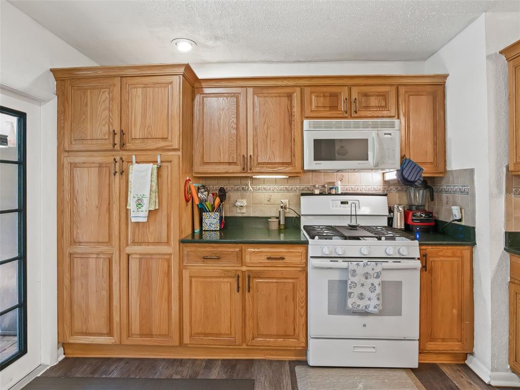 6046 East Loring Lane Inverness, FL 34452 - Photo 16 of 46 a kitchen with white cabinets and sink