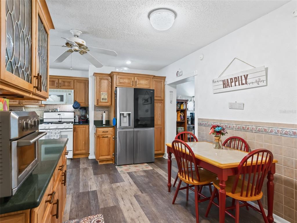 6046 East Loring Lane Inverness, FL 34452 - Photo 17 of 46 a view of a dining room with furniture large window and wooden floor