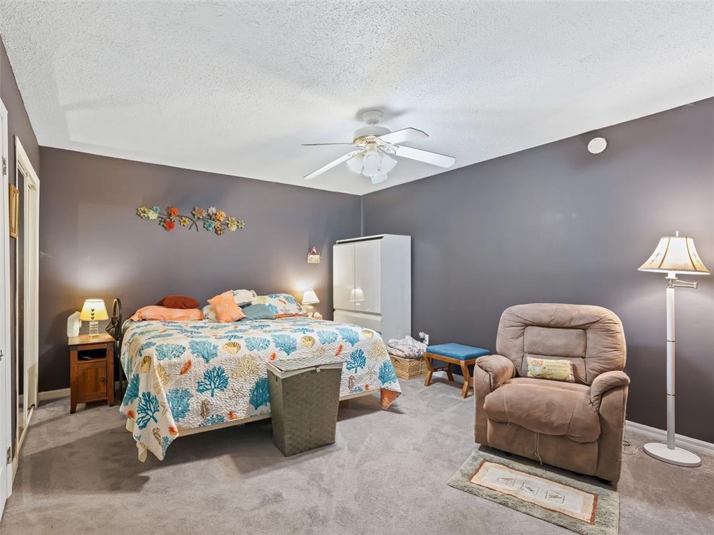 6046 East Loring Lane Inverness, FL 34452 - Photo 27 of 46 a bedroom with a bed and a chandelier