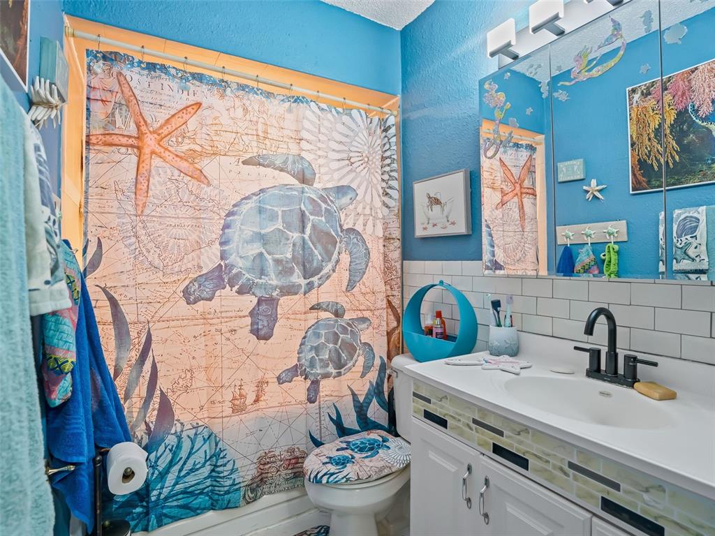 6046 East Loring Lane Inverness, FL 34452 - Photo 34 of 46 a bathroom with a sink toilet mirror and vanity