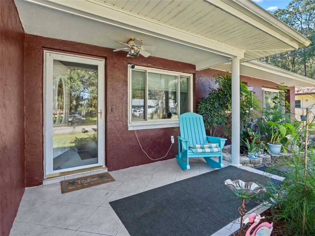 6046 East Loring Lane Inverness, FL 34452 - Photo 4 of 46 a front view of a house with outdoor seating space