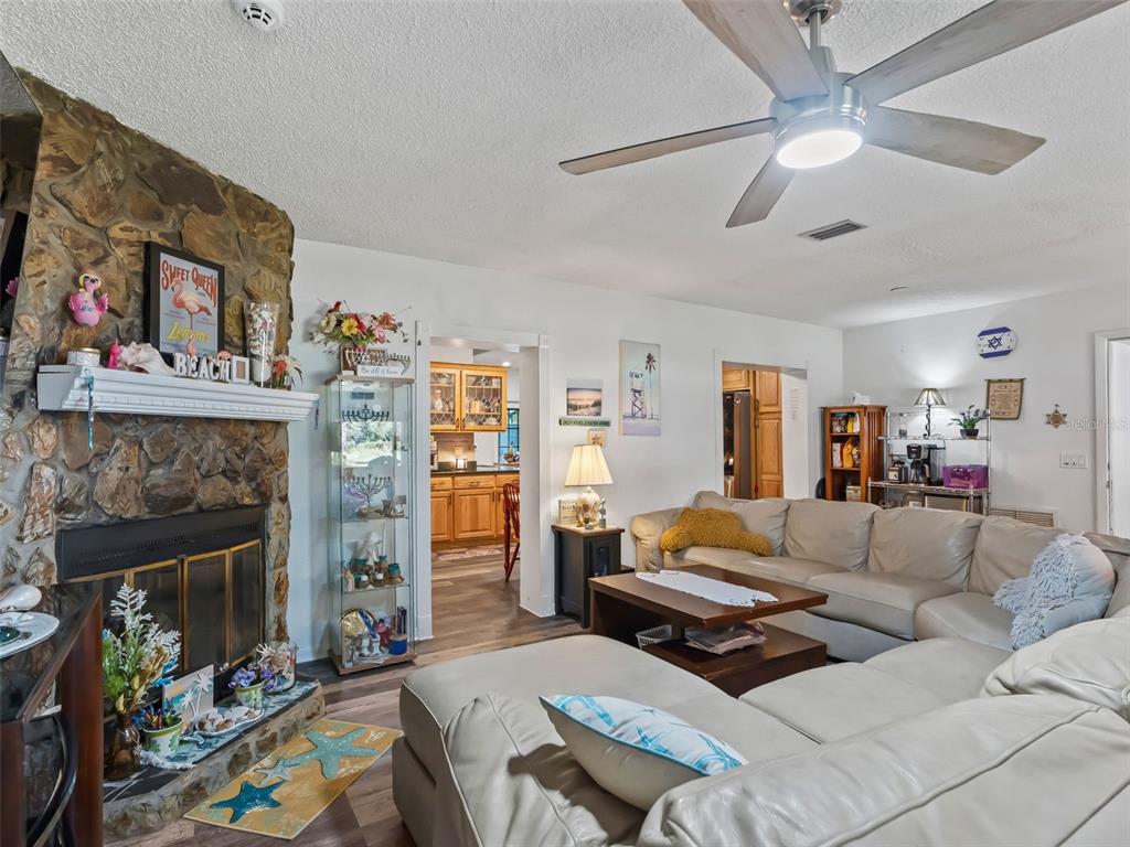6046 East Loring Lane Inverness, FL 34452 - Photo 9 of 46 a living room with furniture and a fireplace