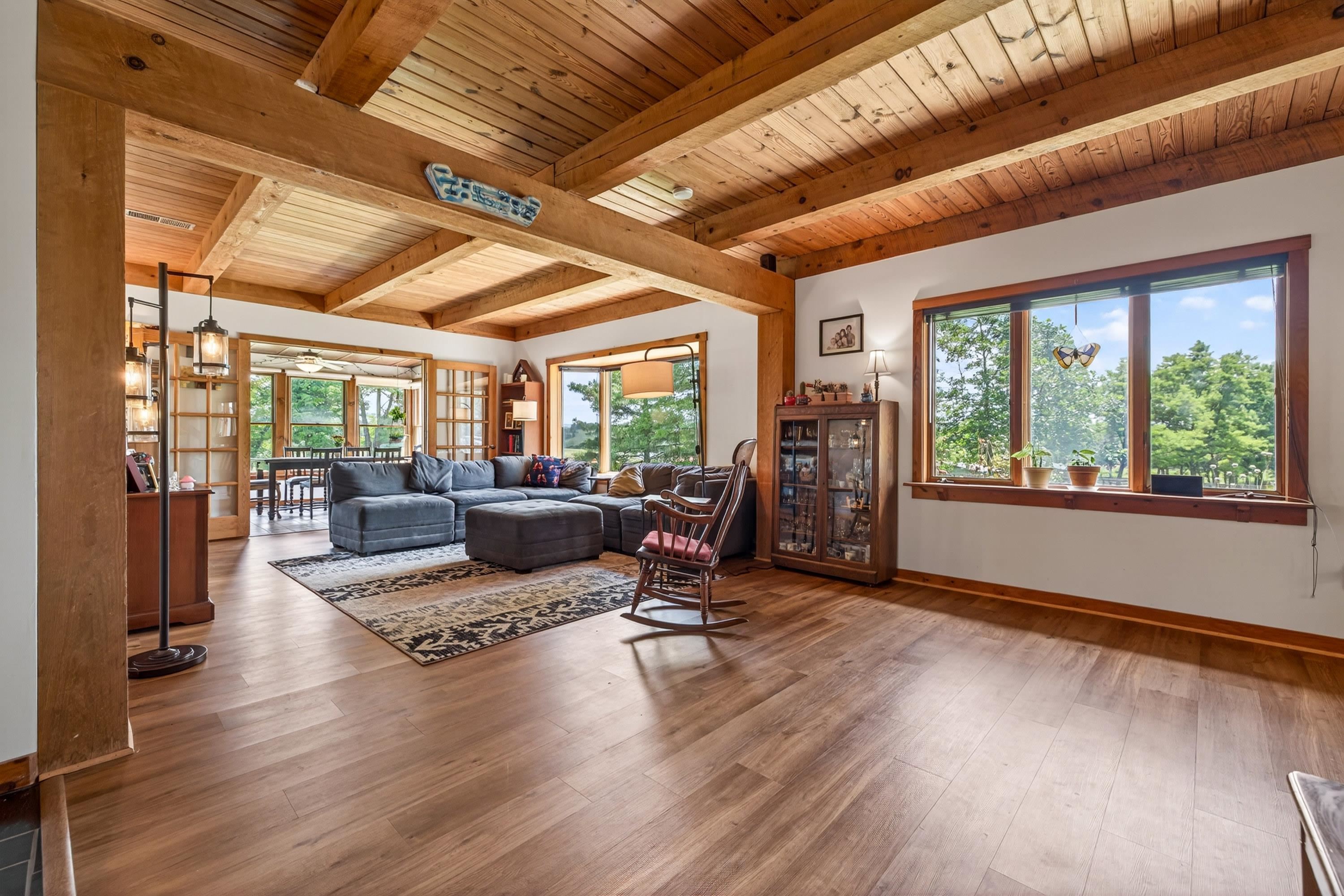 3980 Greenmount Road Harrisonburg, VA 22802 - Photo 7 of 75 The living room is expansive and features hardwood flooring, large windows, decorative ceilings, and plenty of space for gathering with family and friends.