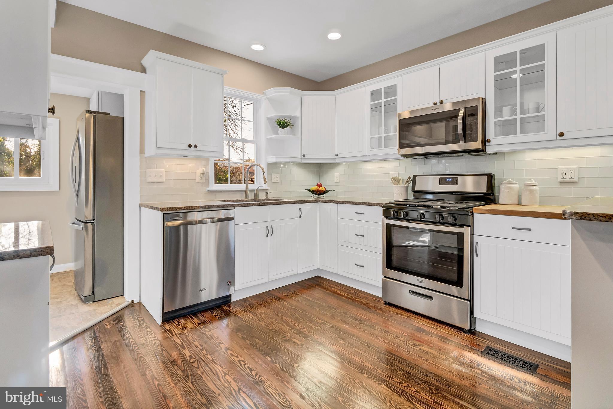 605 St Dunstans Road Baltimore, MD 21212 - Photo 13 of 43 a kitchen with stainless steel appliances granite countertop a stove a sink and a refrigerator