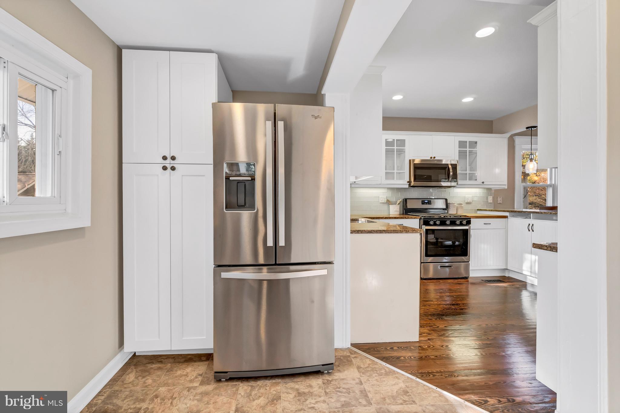 605 St Dunstans Road Baltimore, MD 21212 - Photo 15 of 43 a kitchen with stainless steel appliances granite countertop a refrigerator a stove a sink and a microwave