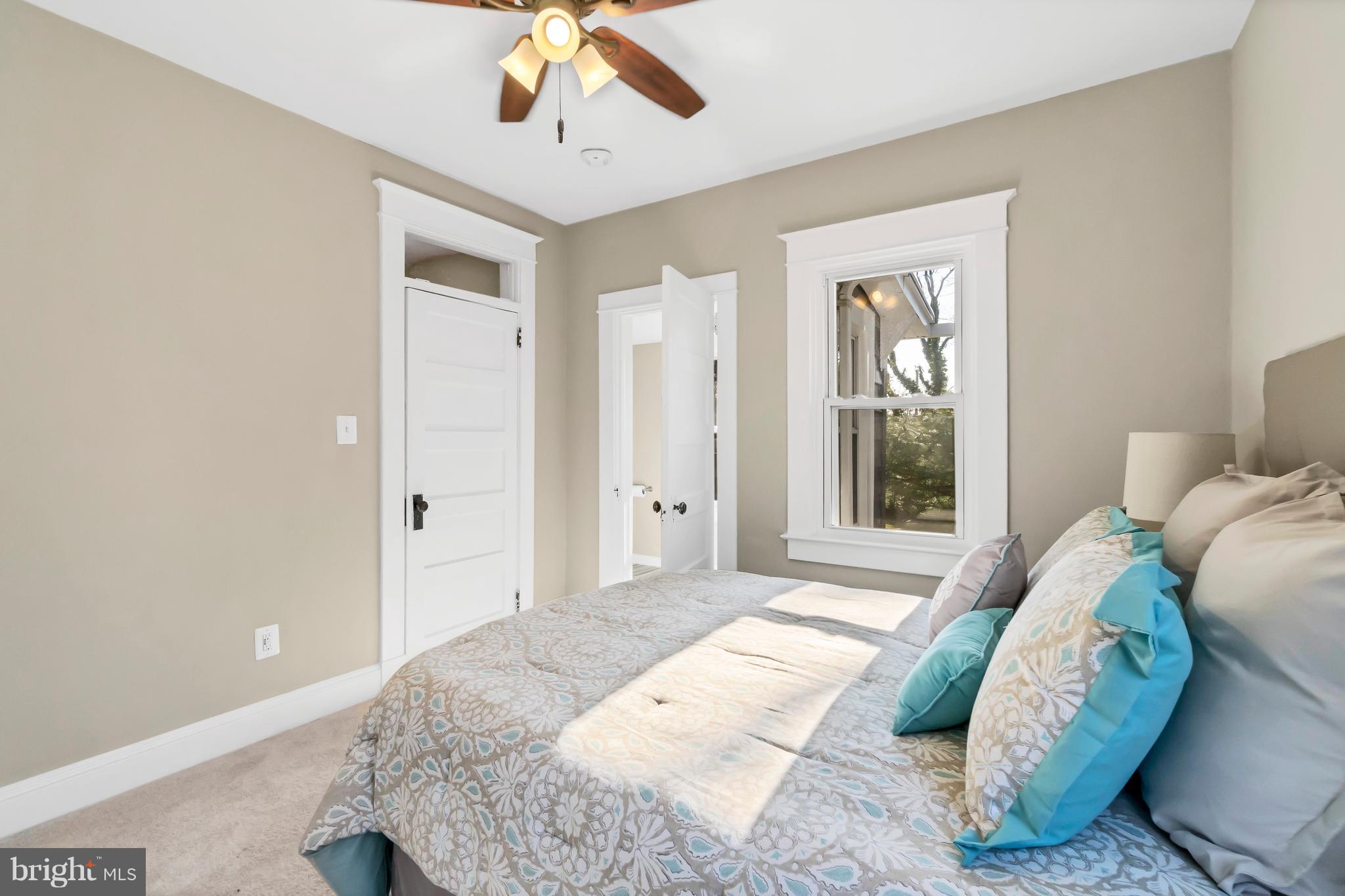 605 St Dunstans Road Baltimore, MD 21212 - Photo 19 of 43 a bedroom with a large bed and a chandelier