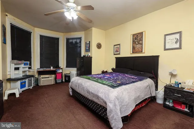 a bedroom with a bed closet and a flat tv screen