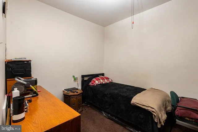 a bedroom with a bed and dresser