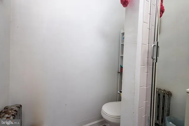 a white toilet sitting next to a bathroom sink