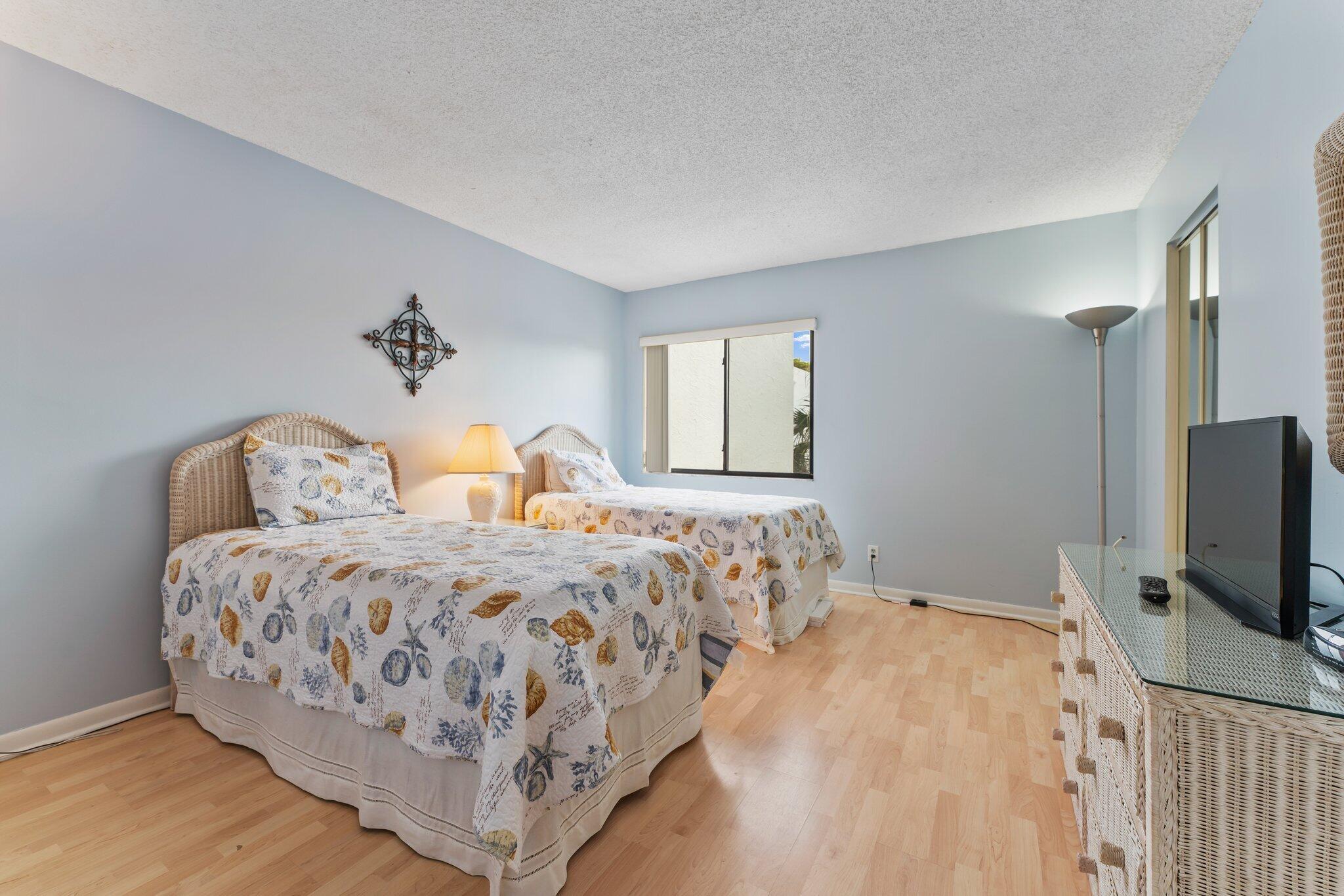 1605 Highway 1, Unit D301 Jupiter, FL 33477 - Photo 22 of 46 a bedroom with a bed and a flat screen tv