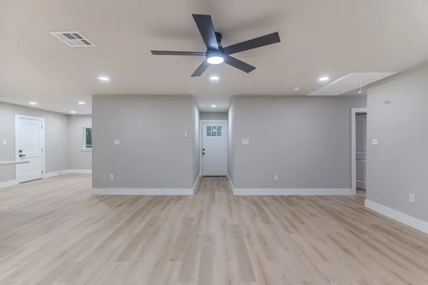 a view of an empty room and wooden floor