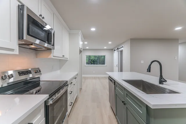 a kitchen that has a sink and a stove