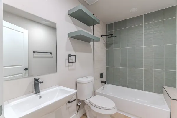 a bathroom with a toilet a sink and bathtub
