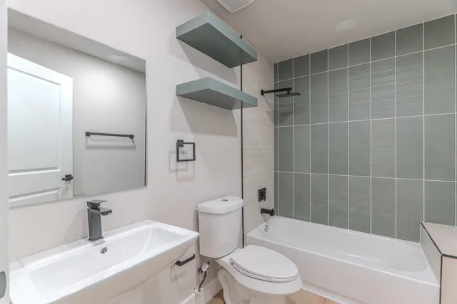 a bathroom with a toilet a sink and bathtub