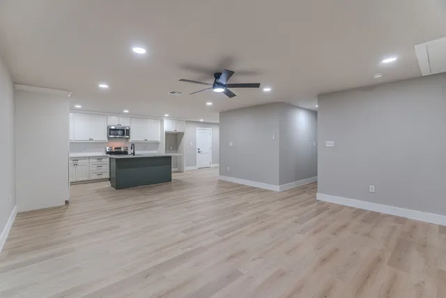 a view of a kitchen with a sink and a stove top oven