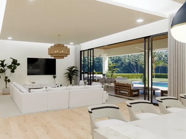 a kitchen with stainless steel appliances kitchen island granite countertop a table and chairs in it