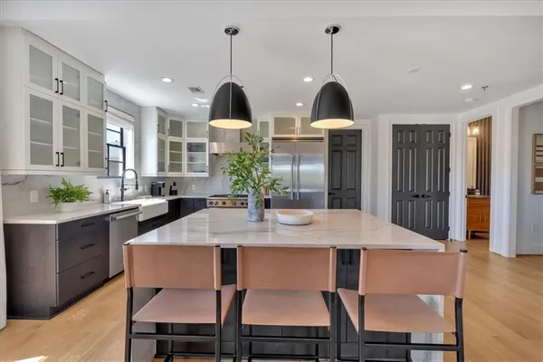 a bathroom with a granite countertop sink toilet and a mirror