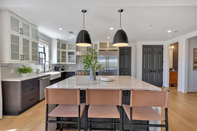 a bathroom with a granite countertop sink toilet and a mirror
