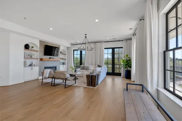 a living room with furniture and a chandelier