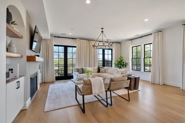a living room with furniture fireplace and flat screen tv