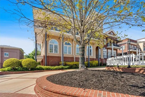 front view of a brick house with a small yard