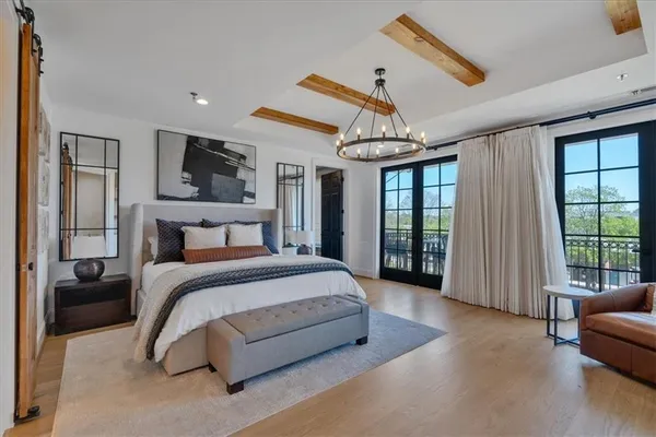 a bathroom with a bathtub a mirror a sink and glass door shower