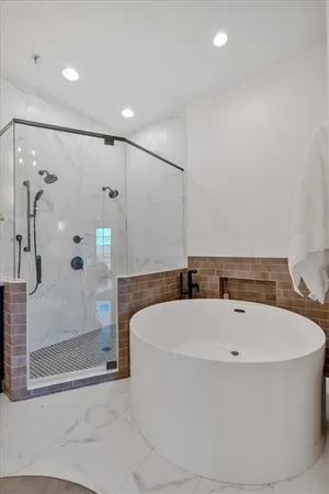 a living room with furniture a flat screen tv and kitchen view
