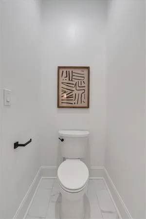 a living room with furniture a rug and wall painting