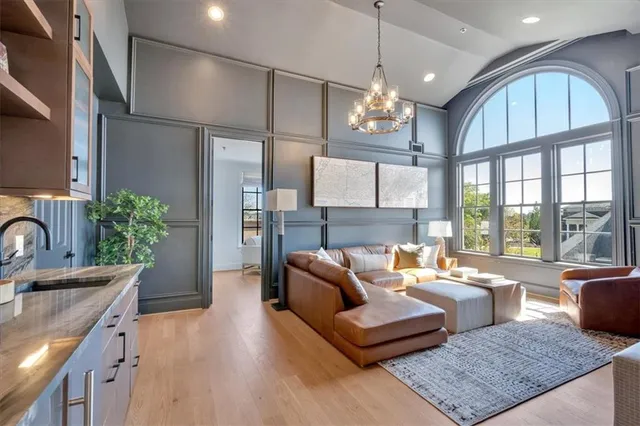 a roof deck with table and chairs and potted plants