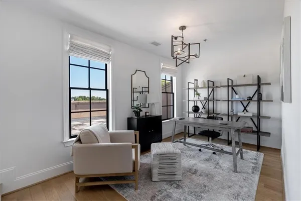 a view of a patio with table and chairs with wooden floor and fence