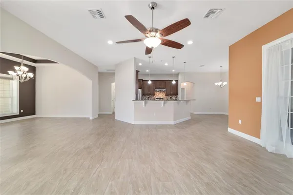 a spacious bathroom with a granite countertop sink and a mirror