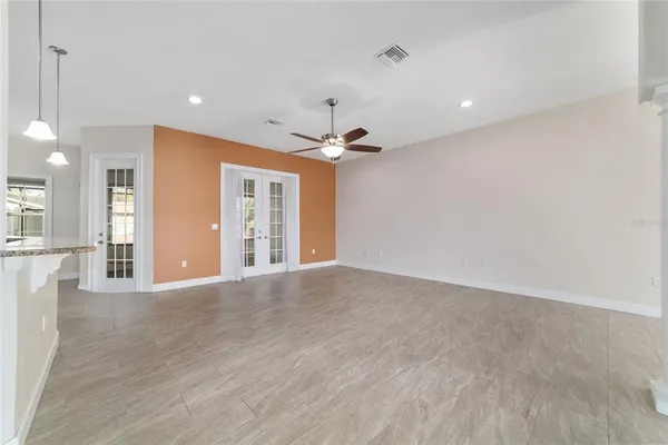 a view of an empty room with a ceiling fan