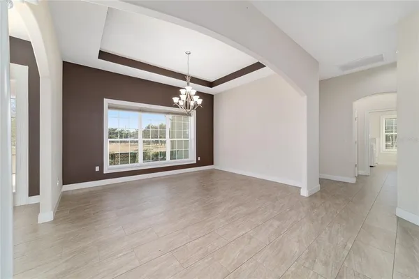 a view of an empty room with a ceiling fan