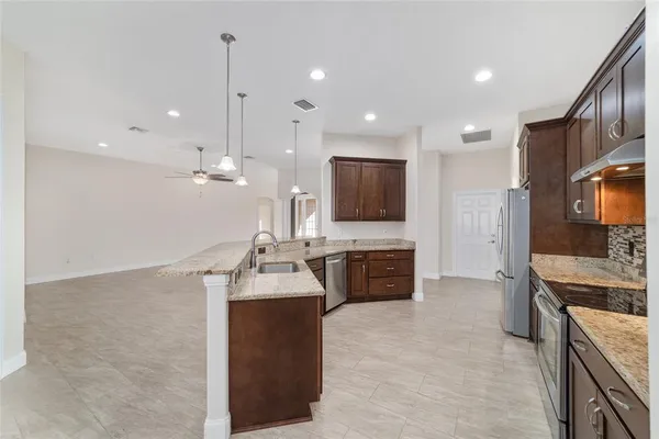 a bathroom with a granite countertop sink toilet a large mirror a bathtub and shower