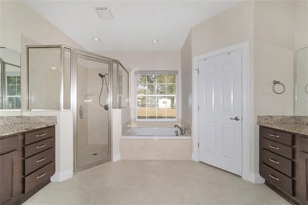 a view of a hallway with a livingroom and a bathroom