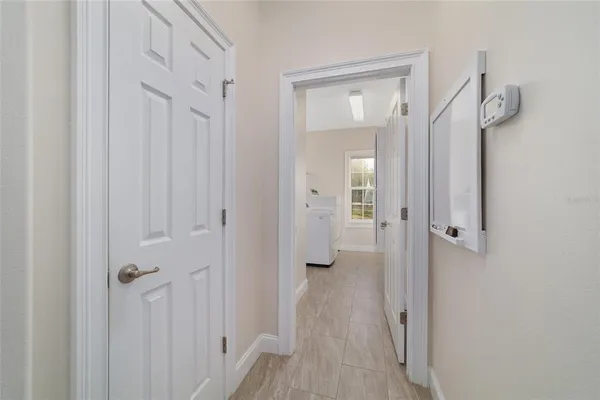 a view of a room with a ceiling fan and a window