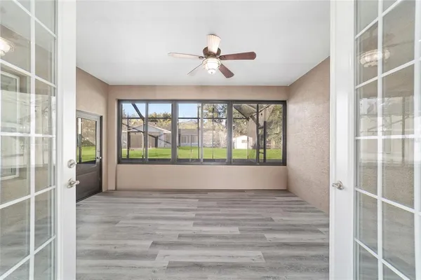 a kitchen with stainless steel appliances kitchen island granite countertop a table chairs sink and cabinets