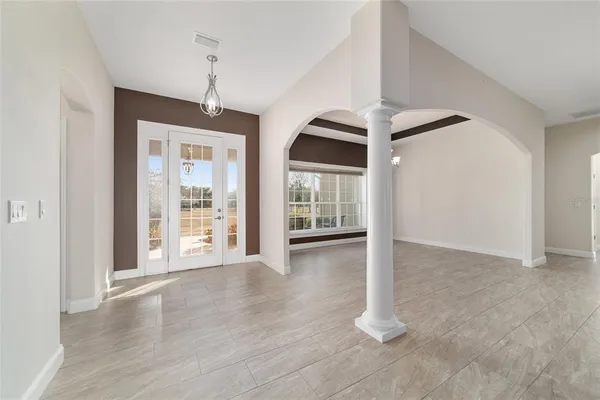 a view of a livingroom with a large window chandelier