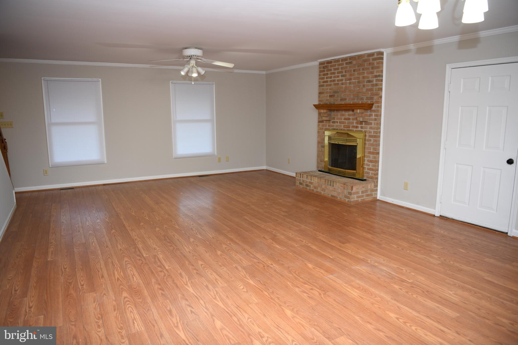 20503 Chestnut Ridge Drive Leonardtown, MD 20650 - Photo 12 of 36 wooden floor in an empty room with a fireplace