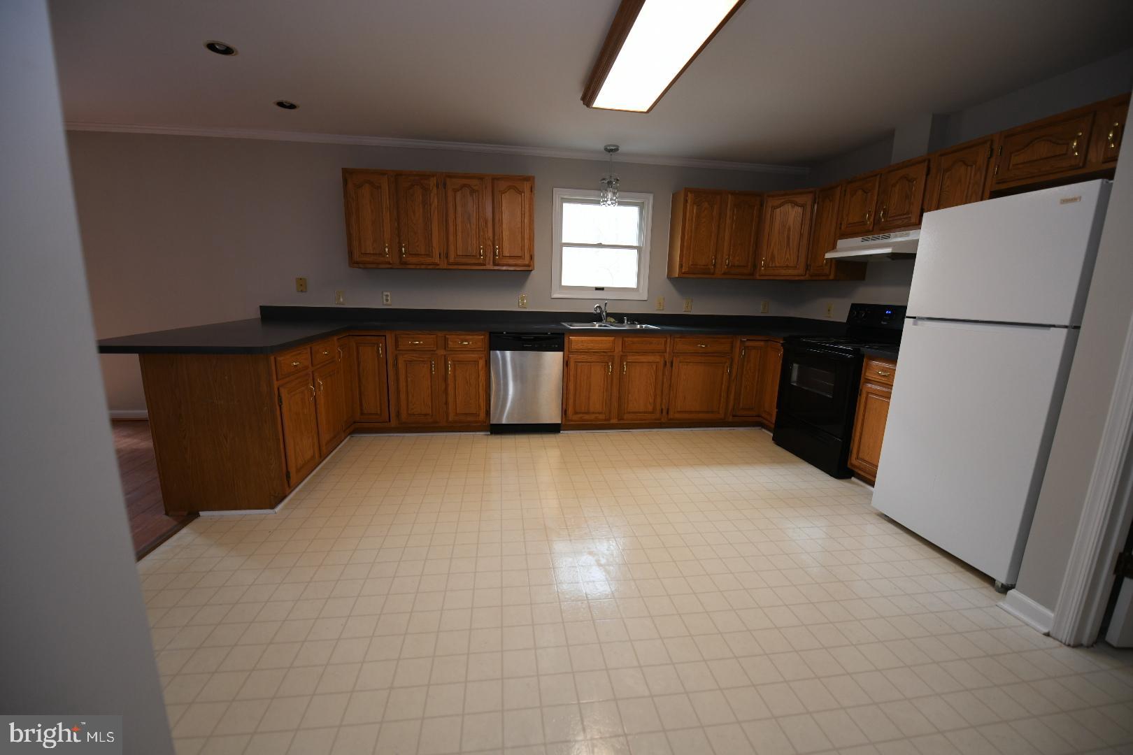20503 Chestnut Ridge Drive Leonardtown, MD 20650 - Photo 14 of 36 a kitchen with refrigerator and cabinets