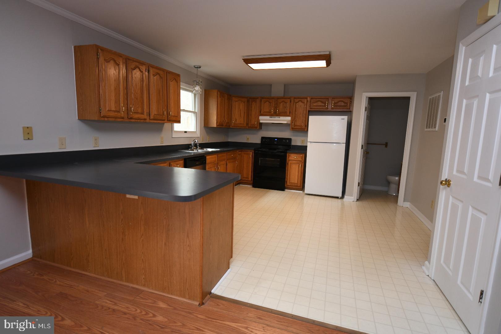 20503 Chestnut Ridge Drive Leonardtown, MD 20650 - Photo 16 of 36 a kitchen with refrigerator and cabinets