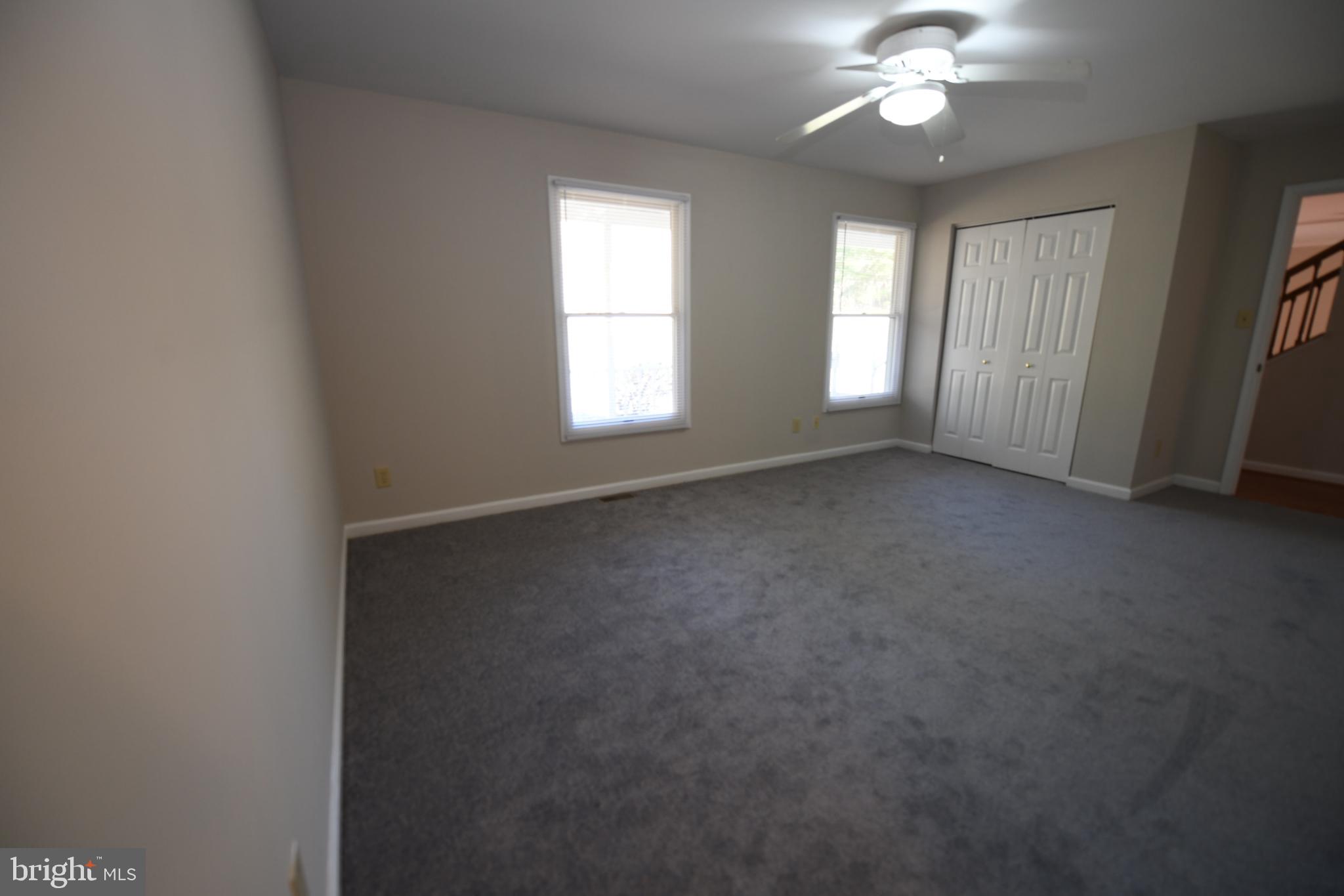 20503 Chestnut Ridge Drive Leonardtown, MD 20650 - Photo 19 of 36 an empty room that has a chandelier fan and a window
