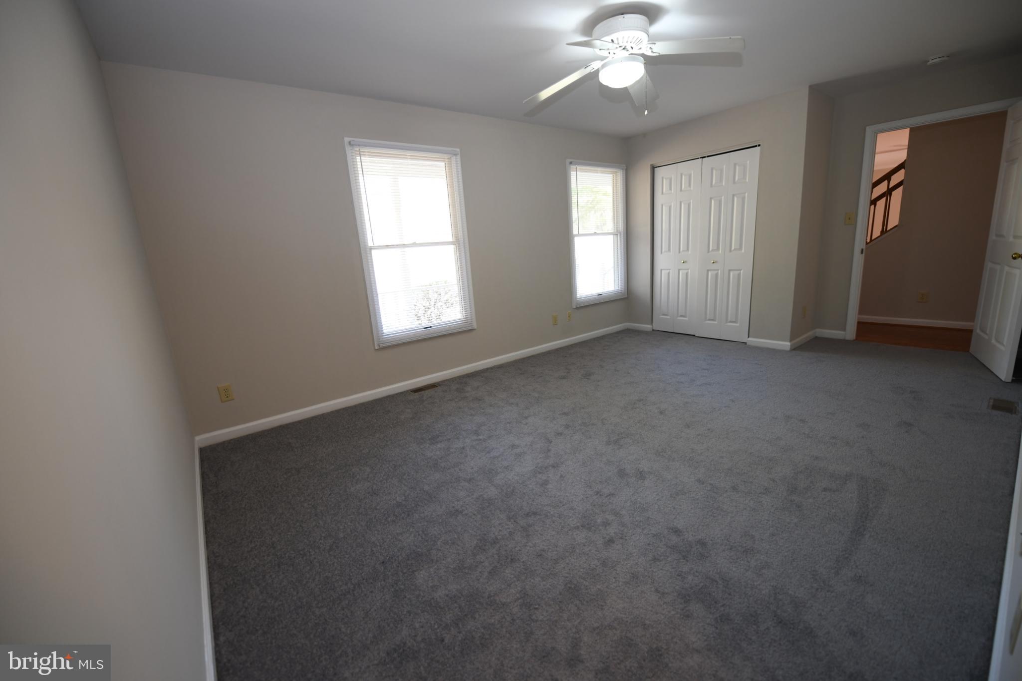 20503 Chestnut Ridge Drive Leonardtown, MD 20650 - Photo 20 of 36 an empty room with windows and chandelier fan