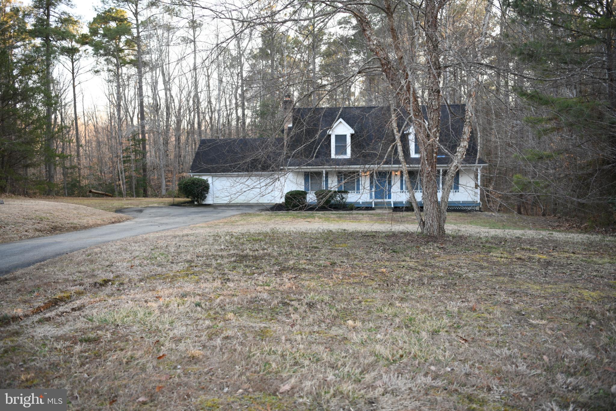 20503 Chestnut Ridge Drive Leonardtown, MD 20650 - Photo 3 of 36 a view of a house with a yard and large trees