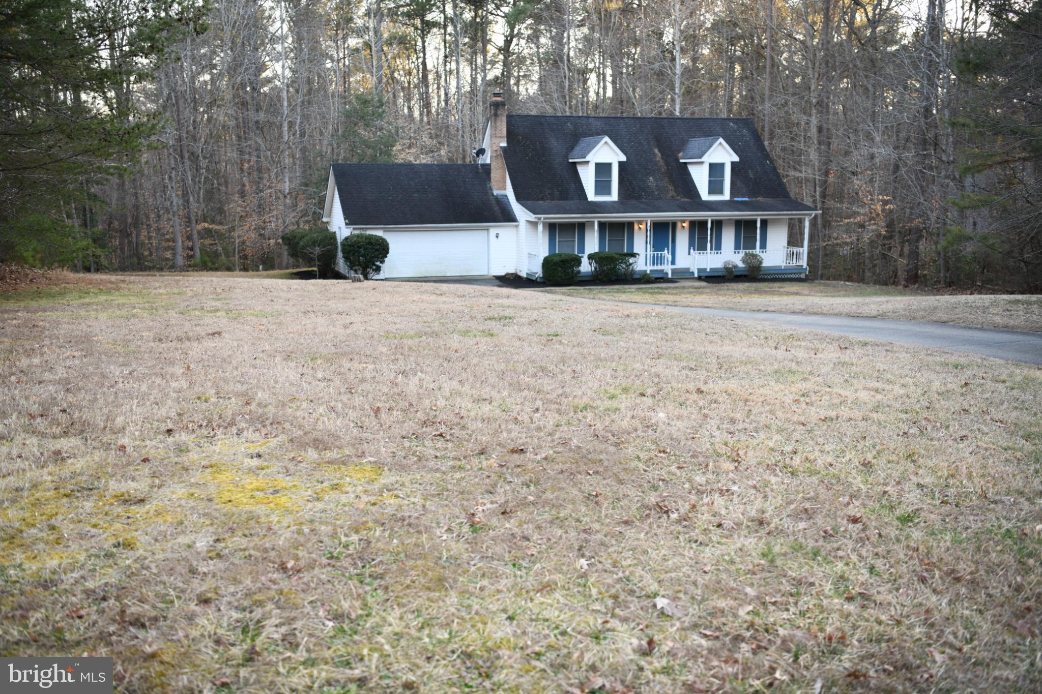 20503 Chestnut Ridge Drive Leonardtown, MD 20650 - Photo 5 of 36 a front view of a house with a yard and a garage
