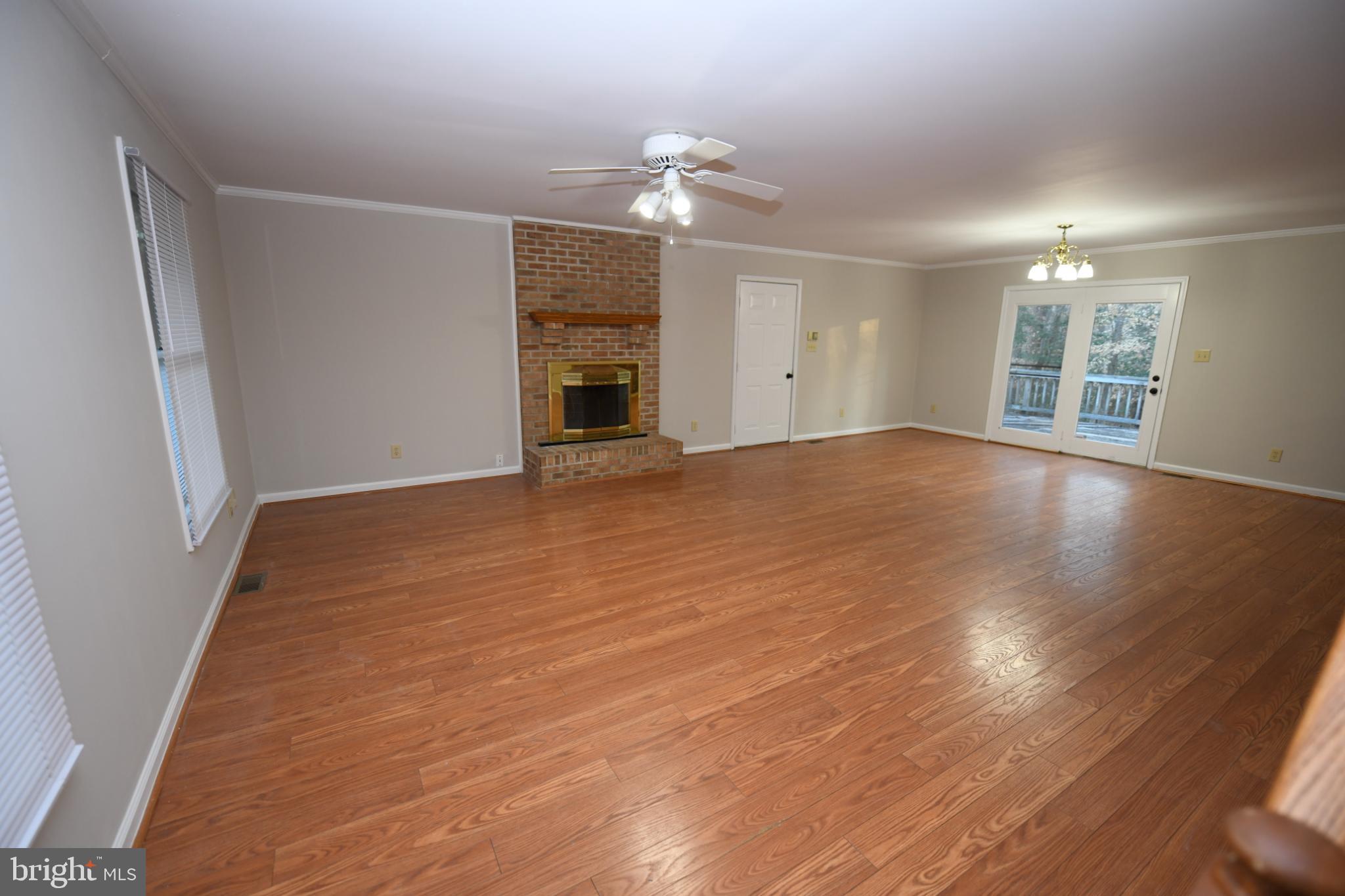 20503 Chestnut Ridge Drive Leonardtown, MD 20650 - Photo 8 of 36 wooden floor in an empty room with a fireplace